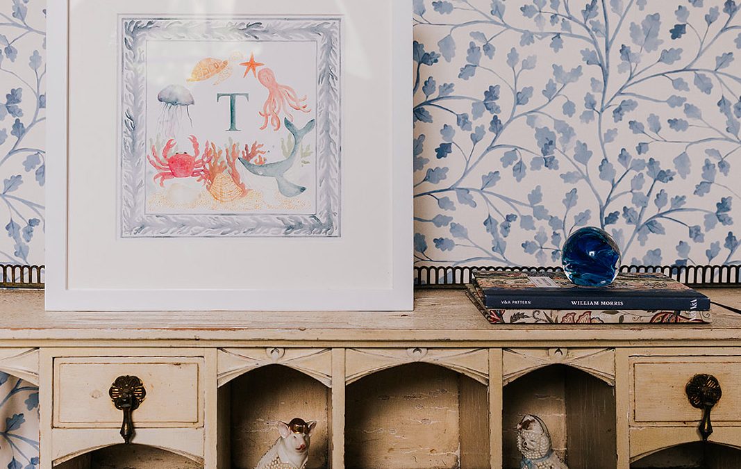 Matilda Trailing leaves blue botanical wallpaper adds a floral touch to the wall behind the desk
