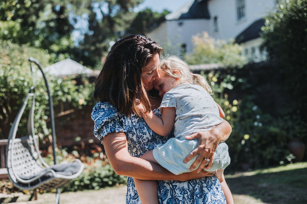 Katie, Willow and Woods pattern designer, cuddles her daughter.